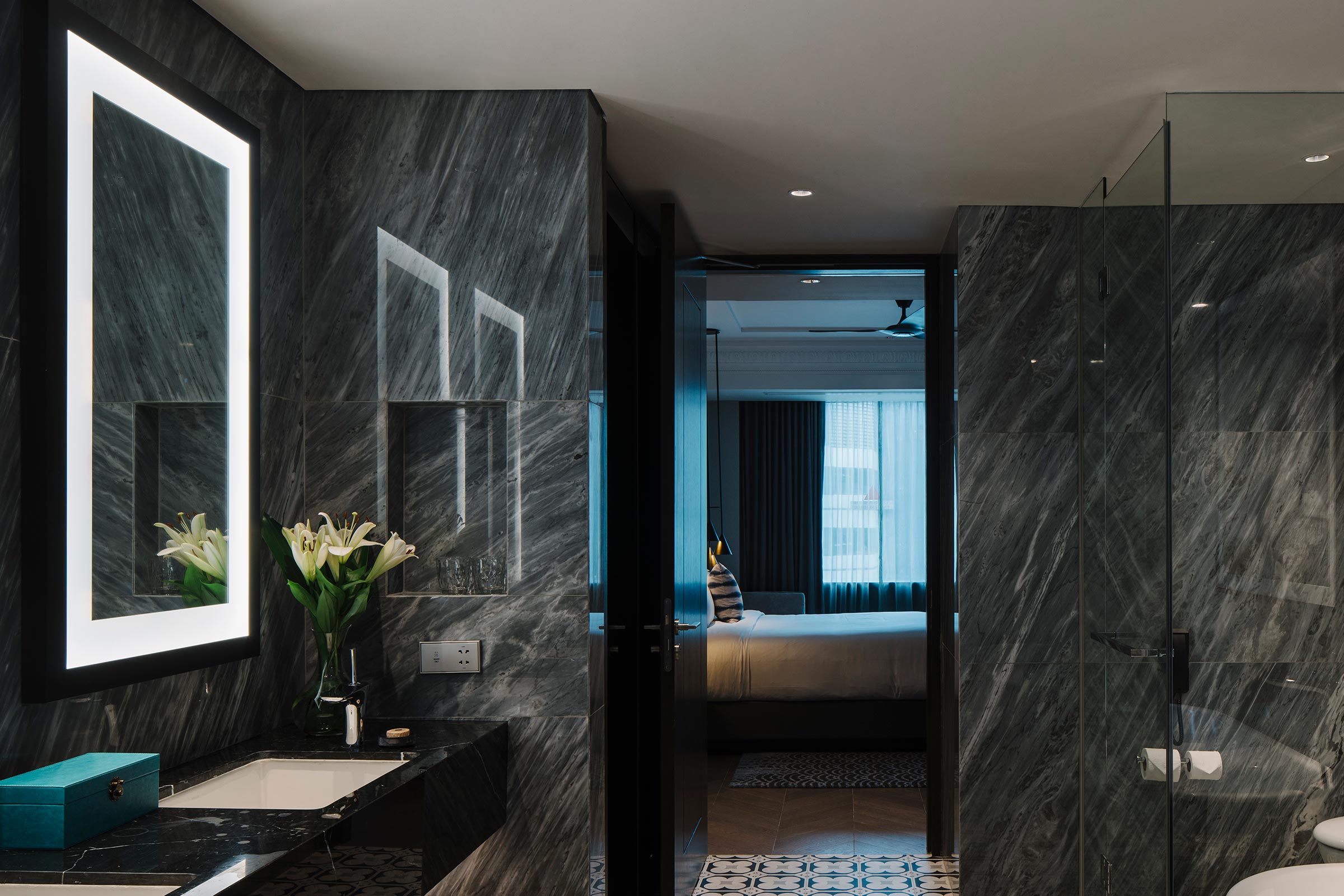 marble bathroom with sink and mirror