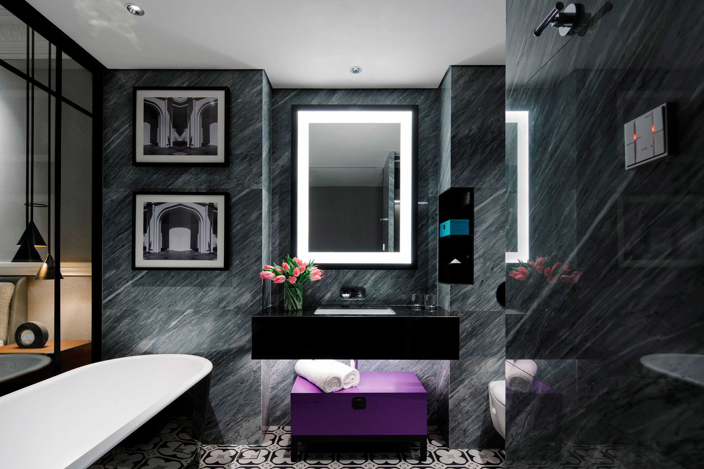 marble bathroom with bathtub and vanity mirror